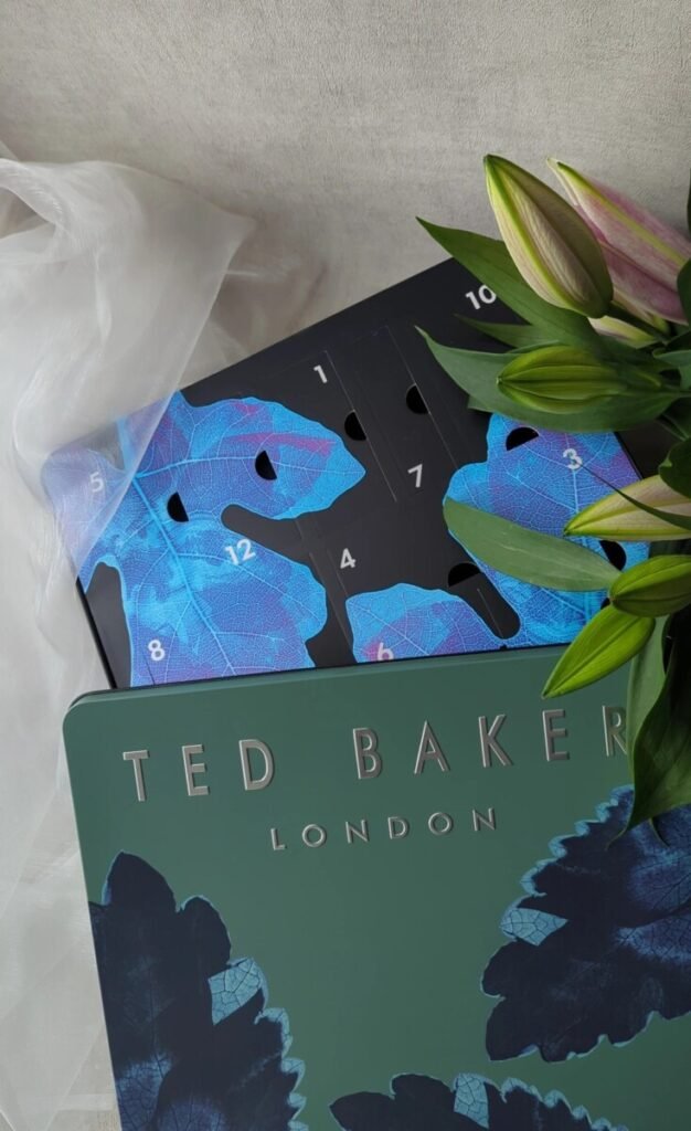 Ted Baker 24 Days of Essentials Advent Calendar 2025 styled with flowers – perfect men’s gift for the festive season.